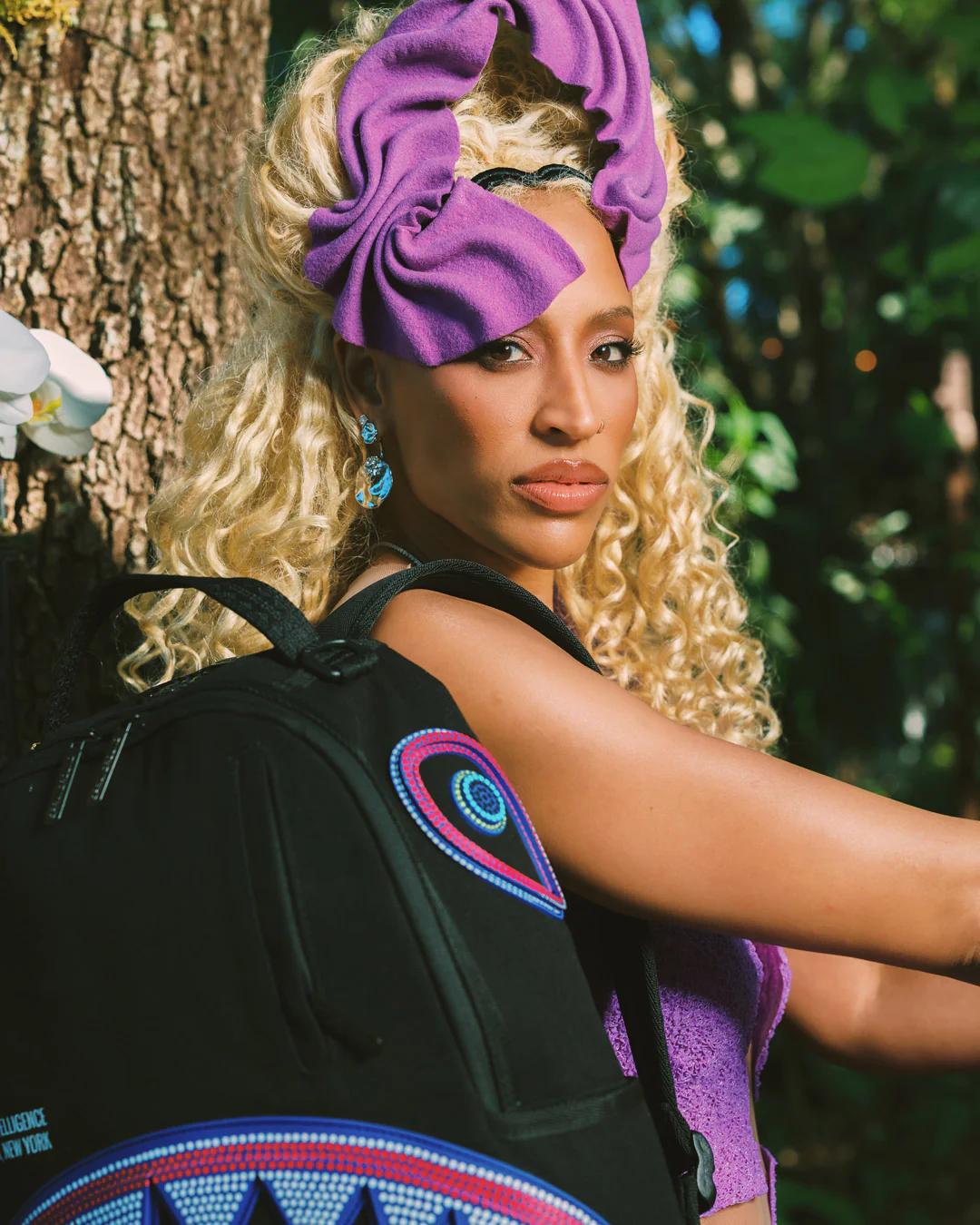 Sprayground Classic | A.I. AFRICAN INTELLIGENCE BORN AND RAISED BACKPACK - SANDFLOWER COLLAB