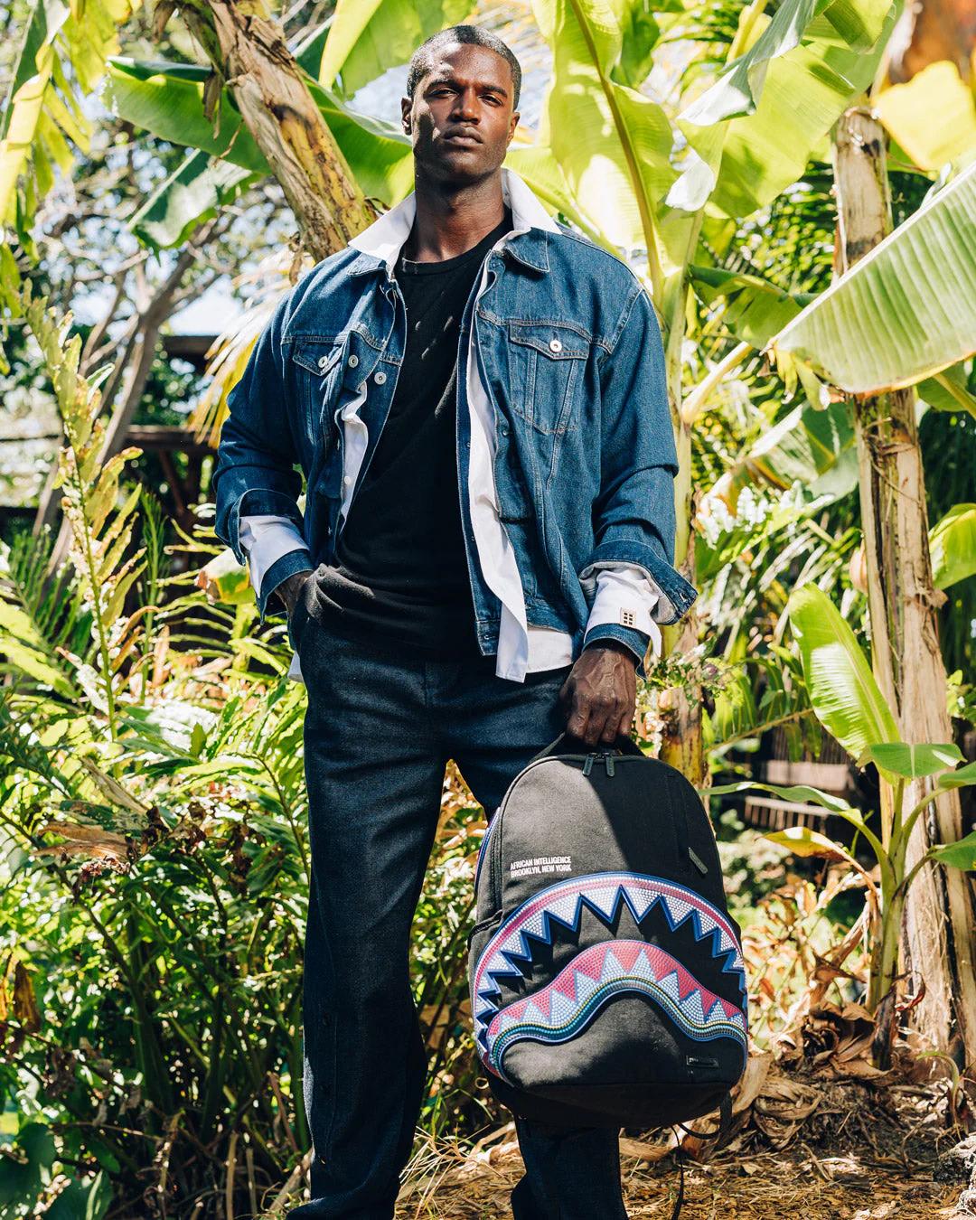 Sprayground Classic | A.I. AFRICAN INTELLIGENCE BORN AND RAISED BACKPACK - SANDFLOWER COLLAB