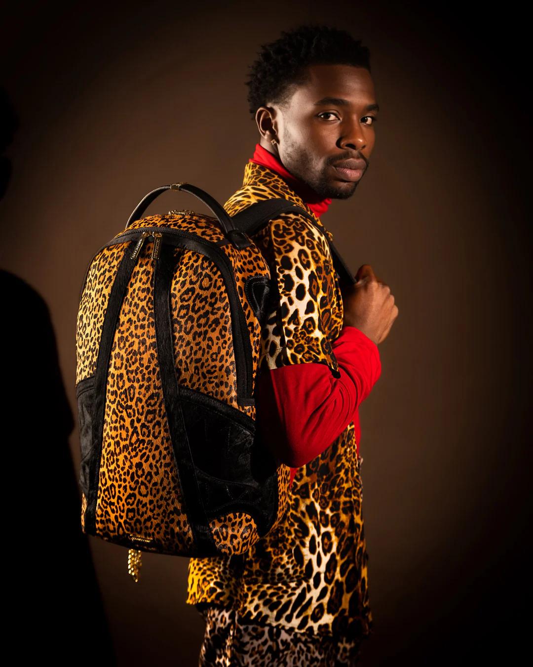 Sprayground Essential | AFRICAN INTELLIGENCE 9 COURAGE LIVES ON BACKPACK - SANDFLOWER COLLAB