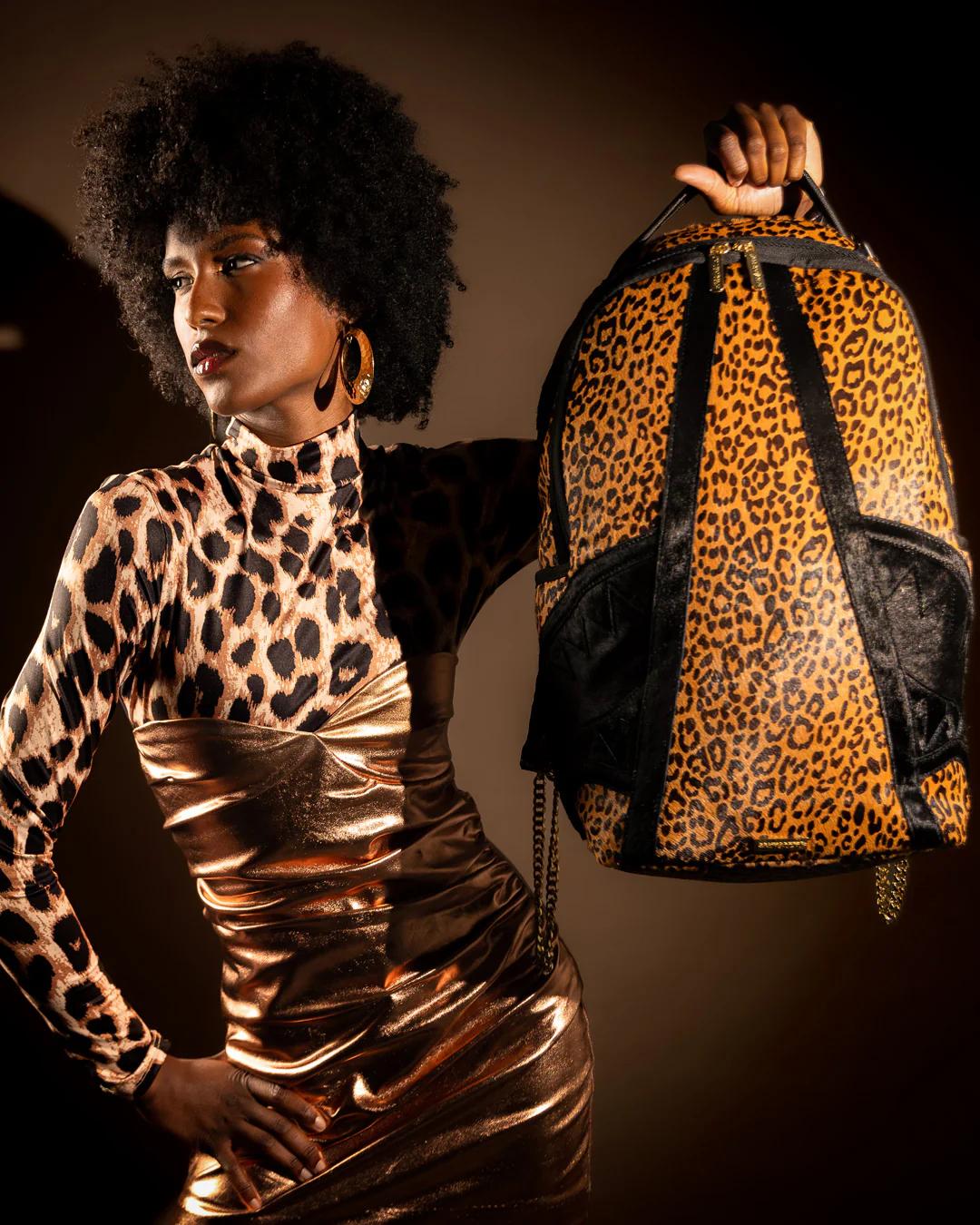 Sprayground Essential | AFRICAN INTELLIGENCE 9 COURAGE LIVES ON BACKPACK - SANDFLOWER COLLAB
