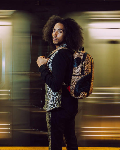 Sprayground Essential | AFRICAN INTELLIGENCE 9 COURAGE LIVES ON BACKPACK - SANDFLOWER COLLAB