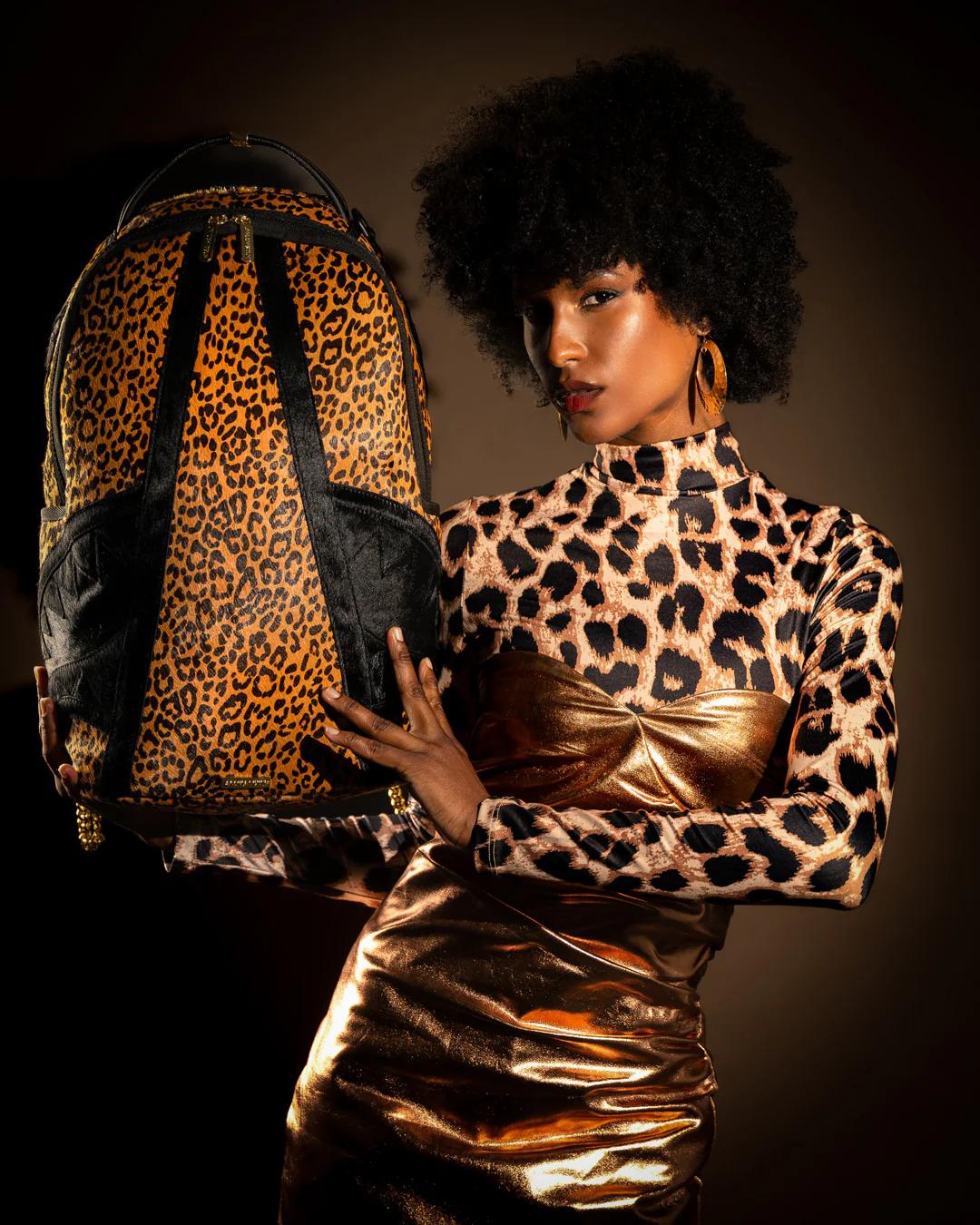 Sprayground Essential | AFRICAN INTELLIGENCE 9 COURAGE LIVES ON BACKPACK - SANDFLOWER COLLAB
