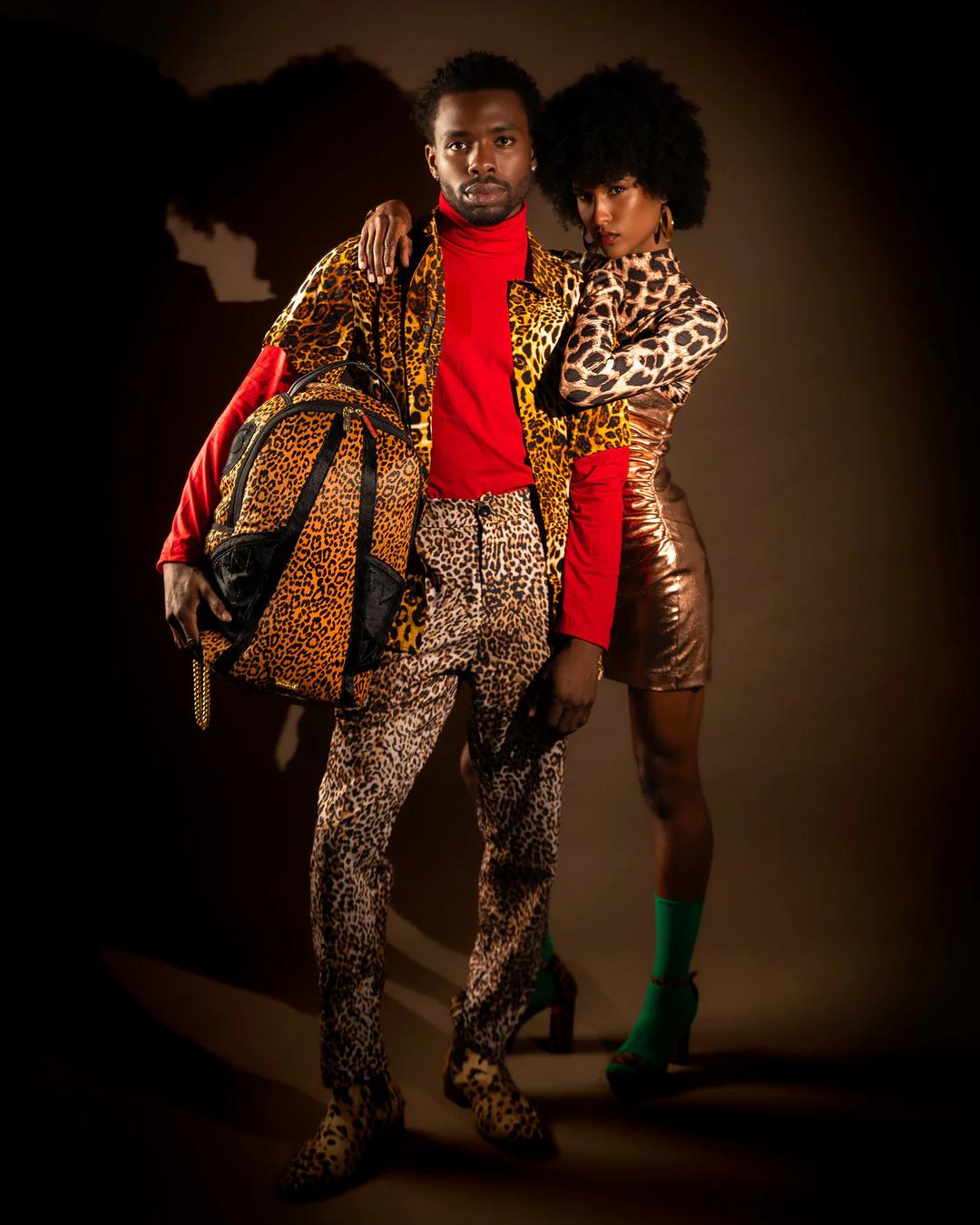Sprayground Essential | AFRICAN INTELLIGENCE 9 COURAGE LIVES ON BACKPACK - SANDFLOWER COLLAB