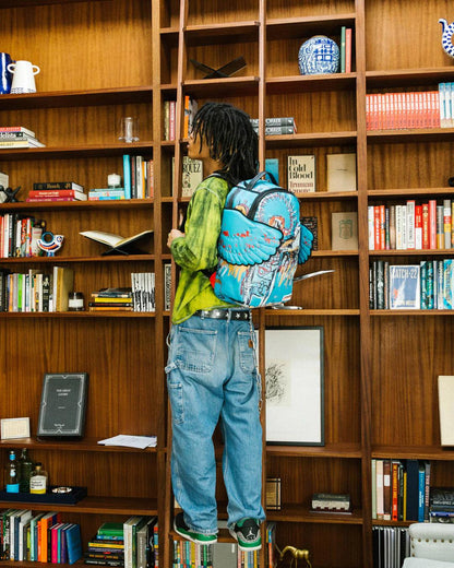 Sprayground Essential | OFFICIAL BASQUIAT UNTITLED (FALLEN ANGEL) 1981 WING BACKPACK (DLXV)