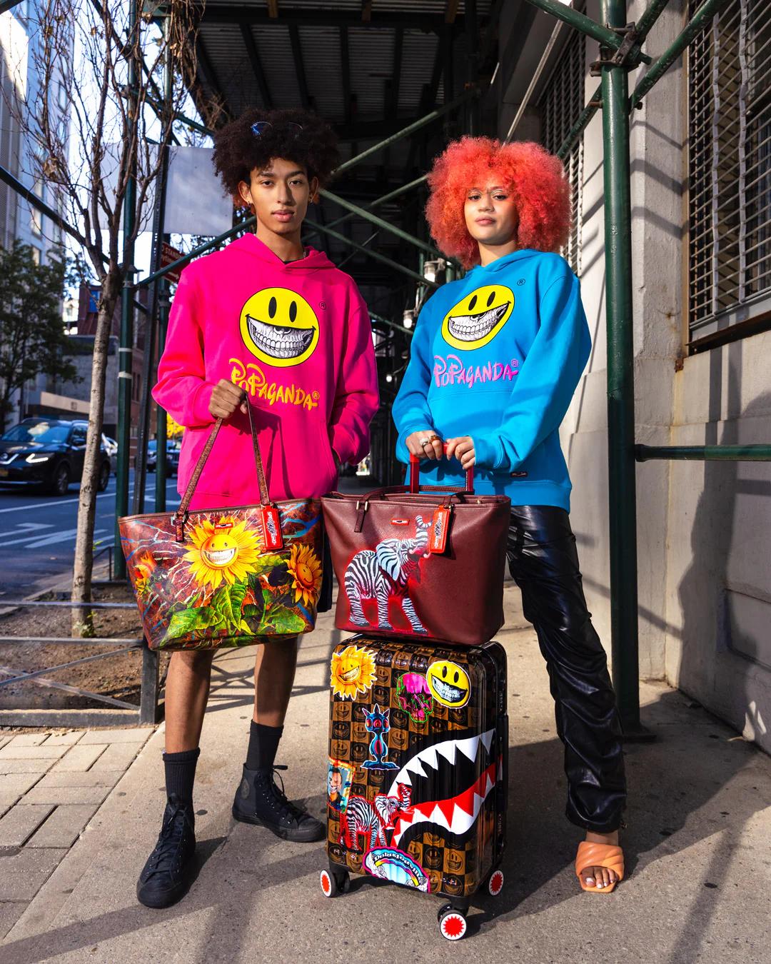 Sprayground Signature | GLOBAL MOGUL POPAGANDA RON ENGLISH EDITION HARDSHELL CARRY-ON LUGGAGE