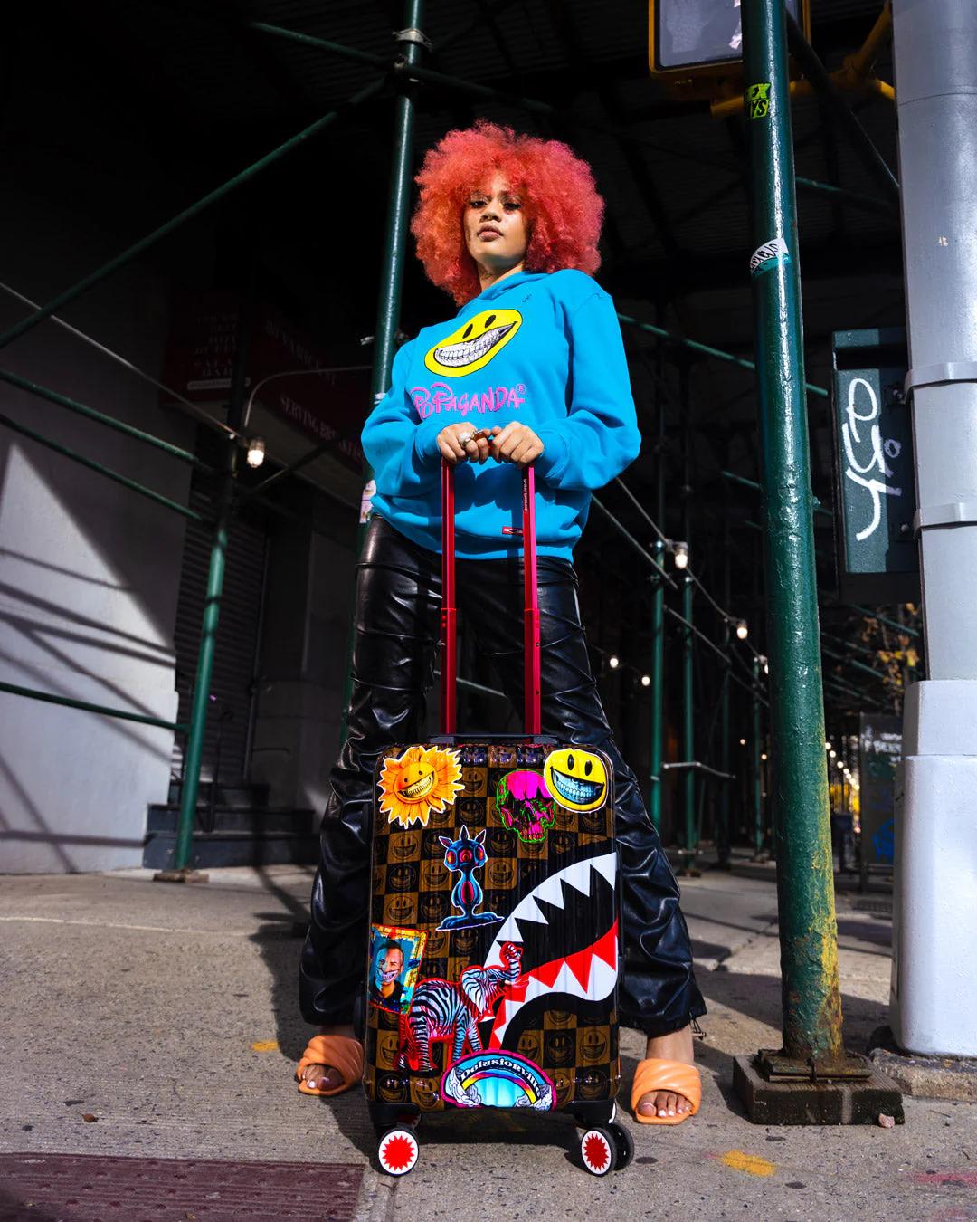 Sprayground Signature | GLOBAL MOGUL POPAGANDA RON ENGLISH EDITION HARDSHELL CARRY-ON LUGGAGE